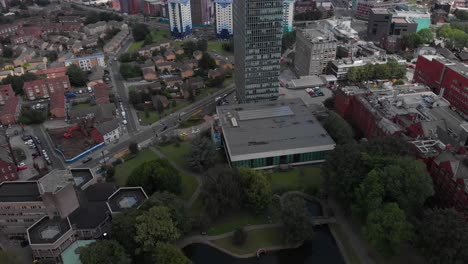 The-University-of-Sheffield-The-Arts-Tower-from-Weston-Park-with-City-of-Sheffield-in-the-background-Sunny-Summer-day-shot-panning-up-while-travelling-back-revealing-city-4K-30FPS