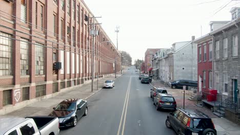 Aerial-dolly-shot-in-city-during-winter,-residential-crime-ridden-neighborhood-near-deserted-factory-with-broken-windows