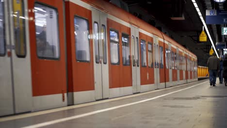 Train-arriving-in-orange-subway-station