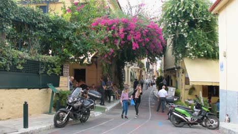 Tourists-walking-in-narrow-street-in-the-traditional-Plaka-Town-near-Acropolis-in-Athens,-Greece