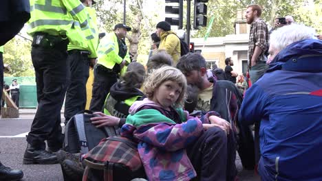 A-small-child-joins-the-protests-with-her-father-during-the-Extinction-Rebellion-protests-in-London,-UK