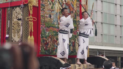 People-Performing-At-The-Giant-Float-Moving-On-The-Street-During-the-Yamaboko-Junko-Processions-Of-Floats-Parade-Of-The-Gion-Matsuri-Festival-In-Kyoto,-Japan