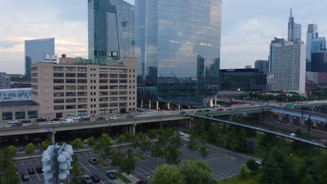 Vertical-rising-aerial-of-large-reflective-glass-skyscraper-in-downtown-Philadelphia