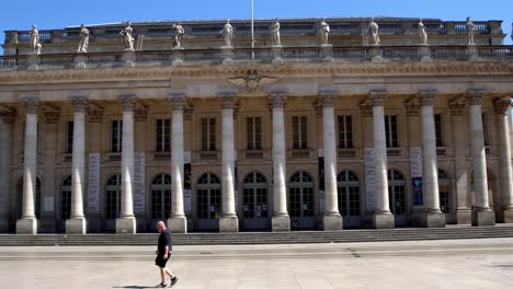 Grand-Theater-Opera-House-front-closed-due-to-the-COVID-19-pandemic,-a-single-man-walks-by,-Locked-stable-shot