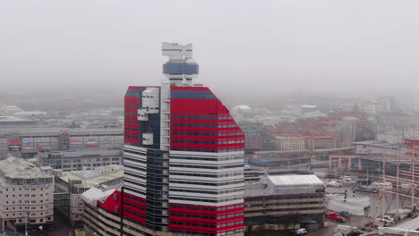 Dron-Que-Rodea-El-Edificio-Del-Pintalabios-En-Gotemburgo,-Día-De-Niebla