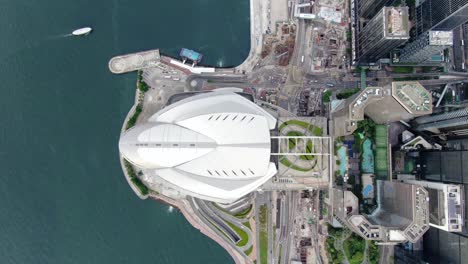 Hong-Kong-famous-Convention-and-Exhibition-Centre-building-in-Victoria-harbour,-Top-down-aerial-view