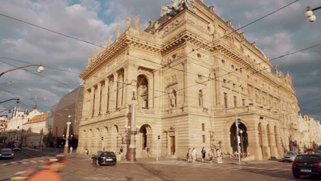 Junction,-tram-and-traffic-in-front-of-National-Theatre-in-Prague,-wide-angle-pan-shot