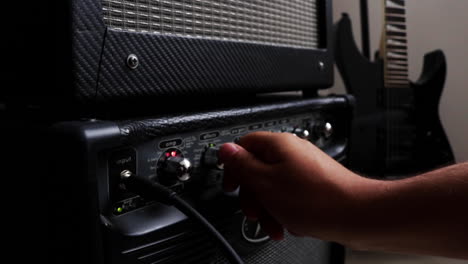 Close--up-of-old-analog-amplifier,-guitar-in-background