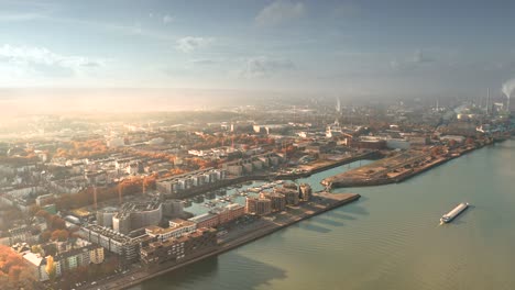 Drone-shot-of-Mainz-the-City-of-Biontech-vaccine-against-Corona-Covid-19-in-Germany-from-an-aerial-view-in-golden-fall-light-and-dramatic-sky-showing-the-town-part-Winterhafen