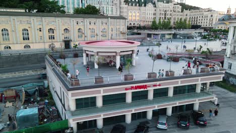 Aerial-reveal-shot-of-the-Poshtova-square-in-Kiev-with-a-girl-looking-at-the-camera