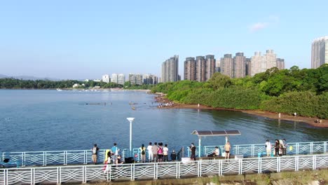 Hong-Kong-Wu-Kai-Sha-beach-and-coastline-with-residential-skyscrapers-in-the-background,-Aerial-view