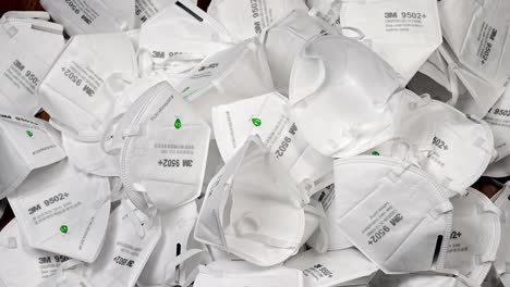 Throwing-medical-masks-onto-pile