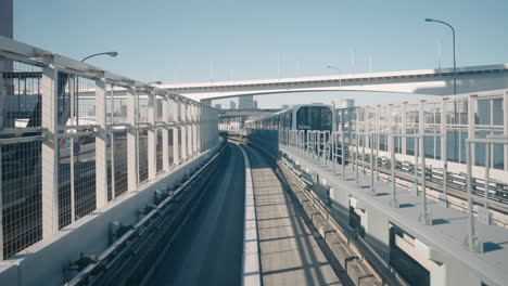 A-point-of-view-shot-of-a-Yurikamome-monorail-moving-along-the-monorail-with-an-opposite-monorail-coming