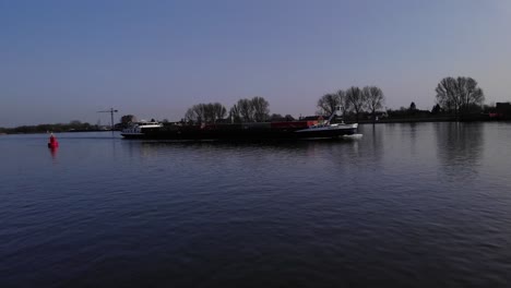 Flying-Towards-Scopus-Container-Ship-Traveling-On-Serene-River-Of-Oude-Maas-In-Netherlands