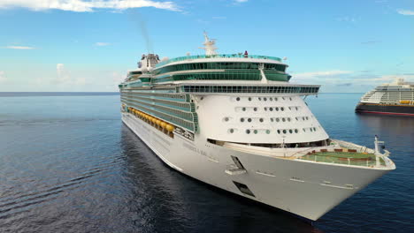 Wide-rotating-drone-shot-of-a-docked-cruise-ship-in-the-Cayman-Islands-with-other-ships-nearby