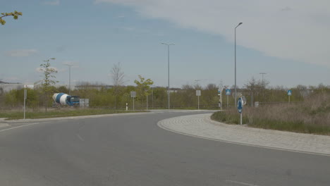 Cars-and-cement-truck-driving-over-busy-roundabout