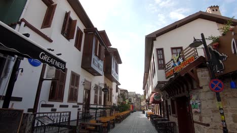 Wide-dolly-shot-of-an-empty-street-in-the-resort-city-of-Antalya-in-Turkey-showing-restaurants-and-seating-areas