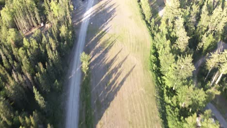 Slow-aerial-footage-flying-over-a-grass-runway-panning-up-with-airplanes-on-the-field-and-the-Matanuska-River-in-the-background