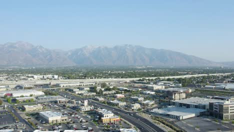 Aerial-circling-over-commercial-area-and-mountain-in-background