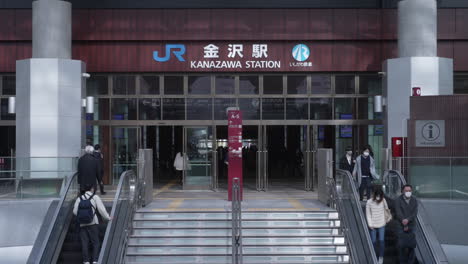 Shot-of-the-east-exit-of-the-JR-Kanazawa-Station-in-daytime-during-the-pandemic-with-tourists-and-commuters-entering-and-leaving-the-station