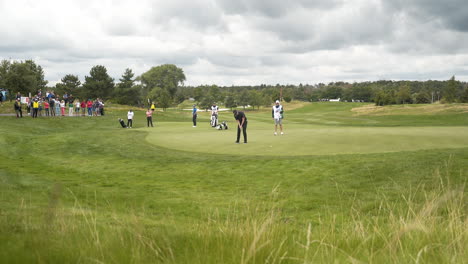 Golf-player-doing-a-final-shot-at-a-tournament-on-a-golf-course-green