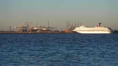 Cruise-ship-docked-at-the-shipping-terminal-and-harbor---slow-motion-waves-rolling-in-on-a-hazy-day