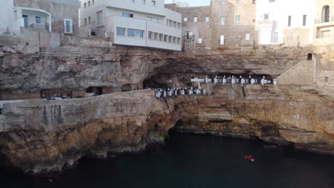 Aerial-flying-towards-Grotta-Palazzese-Restaurant,-Polignano-a-Mare,-Italy