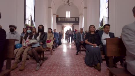 Dolly-shot-inside-a-church-chapel-during-a-baptism-mass-at-an-old-mexican-hacienda