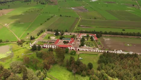 Aerial-flying-over-rural-agriculture-farm-in-luciernagas-Mexico-on-overcast-day