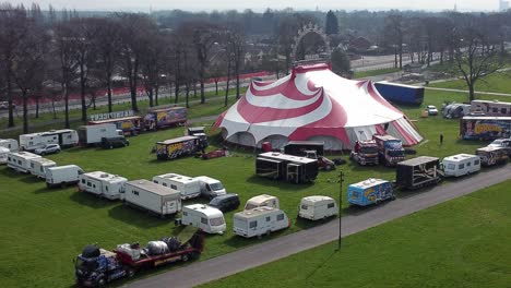 Planet-circus-daredevil-entertainment-colourful-swirl-tent-and-caravan-trailer-ring-aerial-view-rising-tilt-down