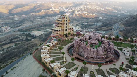 Aerial-view-away-from-the-Al-Khulb-Park-and-Restaurant,-in-Saudi-Arabia---rising,-pull-back,-drone-shot