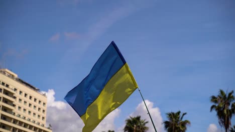 Impactful-Ukrainian-flag-waving-against-blue-and-cloudy-sky