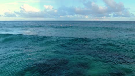 aerial-pullout-of-wave-following-camera-with-surfers-in-the-background