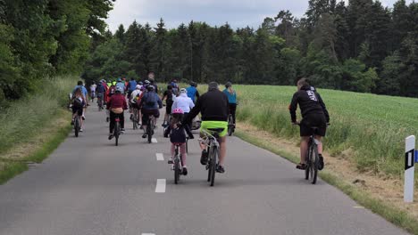 Pov-following-shot-of-many-cyclist-on-bicycle-riding-on-freeway-in-Switzerland-during-Slowup