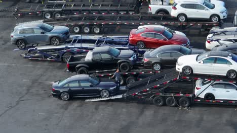 Brand-new-sedan-being-loaded-onto-car-carrier