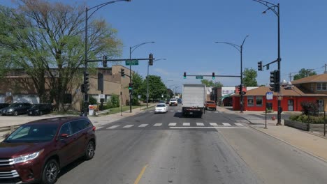 Traveling-in-the-Illinois-Chicago-land-area,-suburbs,-streets,-and-highways-in-POV-mode-passing-old-building