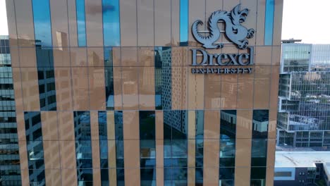 Aerial-rising-shot-of-building-on-Drexel-University-with-large-logo