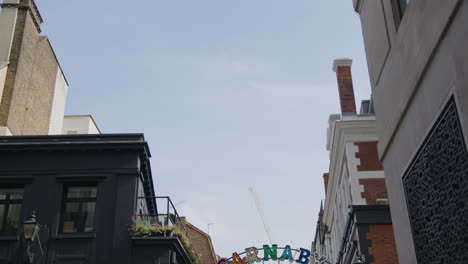 Establishing-Shot-Of-Famous-Shopping-Street-Carnaby-Street-In-Soho-London-City-Of-Westminster,-United-Kingdom-With-People-Walking-During-The-Daytime