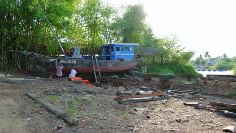 A-skilled-group-of-artisan-ship-restoration-workers-starts-the-laborious-process-of-maintaining-a-classical-wooden-fishing-ship