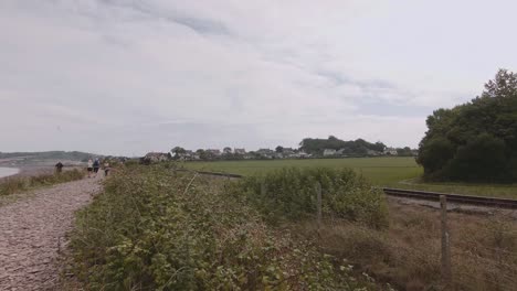 Vintage-passenger-train-moving-through-the-countryside-in-Blue-Anchor,-England