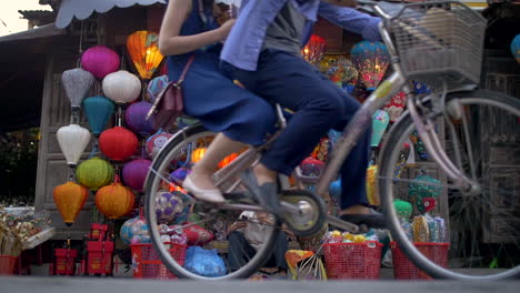 A-Vietnamese-man-sits-outside-his-lantern-shop-smoking-and-using-his-phone