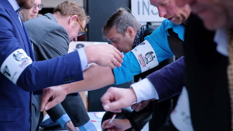 Riders-getting-their-armbands-after-registering-at-the-Distinguished-Gentlemans-Ride-in-Ghent-Belgium