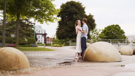 Beautiful-young-couple-dancing-in-slow-motion-in-a-park