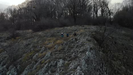 Children-play-on-edge-of-cliff---aerial-tracking-shot