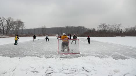 A-hyperlapse-wide-angle-shot-behind-the-pond-hockey-goal-keeper-of-the-entire-field-as-the-game-goes-on