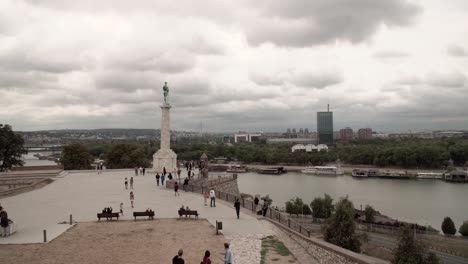 Tourists-walking-around-the-Pobednik-monument-at-the-fortress-in-Belgrade,-Serbia