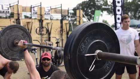 Tattooed-Athlete-Performing-a-Power-Clean-Press-at-a-Cross-Fit-Competition