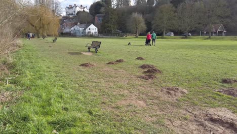 Ross-on-wye,-by-river-in-early-spring-people-out-dog-walking