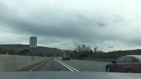 Point-of-view-of-the-wind-shield-as-a-car-drives-on-the-highway