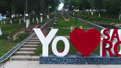 Low-horizontal-pan-shot-of-large-letter-sign-in-front-of-steep-stairway-in-Santa-Rosa-de-Copán,-Honduras